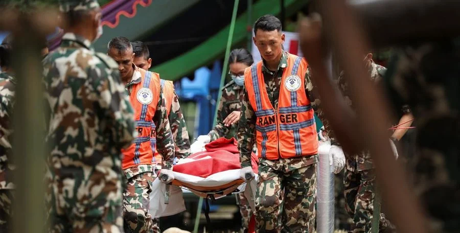 Rescuers aiding flood survivor